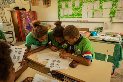 Class 4 students working against the clock to complete questions during a "rotating workshops" activity in Suango Primary School, Efate in Suango, Port Vila, Vanuatu