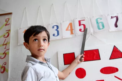 A boy learns how to read numbers on her first day in school after the summer holidays, Azerbaijan.
