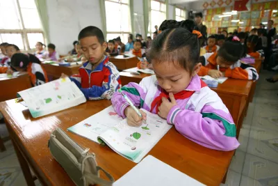 In a clean,bright child-friendly school environment, a girl figures out a math problem at Doujiang Township Primary School, China.