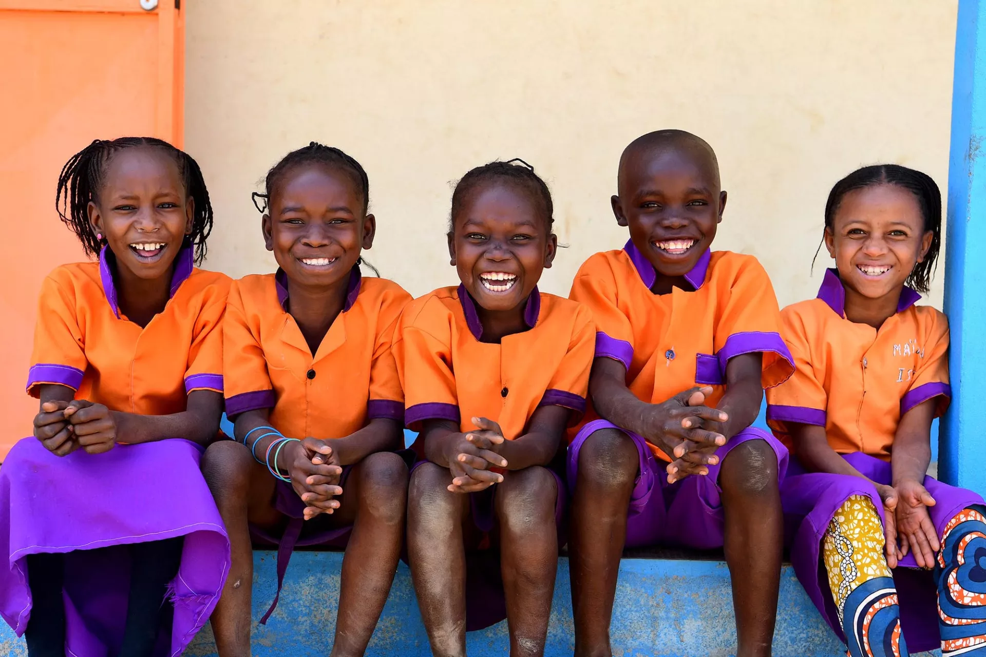 A group of children pose for a photo at the playground of their primary school in Cameroon
